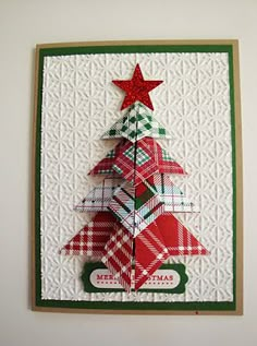 a christmas tree made out of paper on top of a white card with red and green plaid