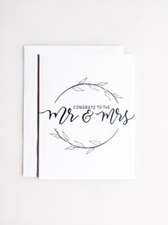 congratulations to the mr and mrs card on top of a white envelope with blue ink