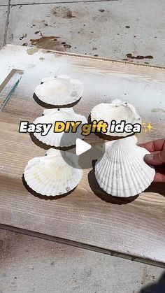 the person is making seashells out of wood