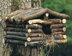 a bird house made out of tree logs