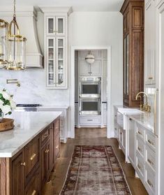 an instagramted photo of a kitchen with white cabinets and wood flooring on the walls