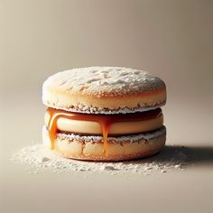 two donuts covered in icing and caramel on top of white powdered sugar