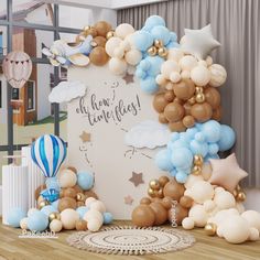 a balloon arch with stars, clouds and balloons for a baby's first birthday