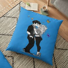 a blue floor pillow with a drawing of two people kissing