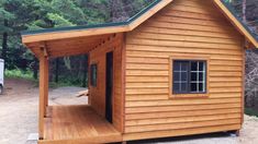 a small wooden cabin sitting in the middle of a forest