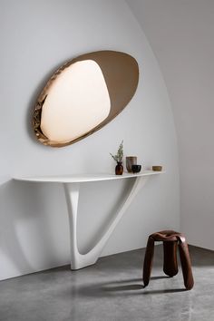 a white table with a light on it and a small stool in front of it