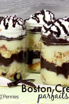 three jars filled with desserts sitting on top of a table