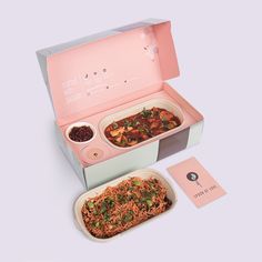 a pink box with two dishes in it