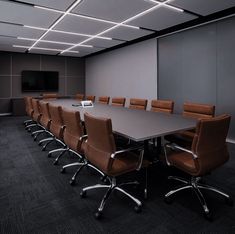 an empty conference room with chairs and a large table