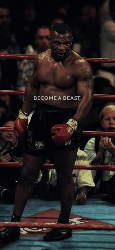 a man standing in the middle of a boxing ring