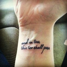 a woman's wrist tattoo with the words and in time, she is go shall pass