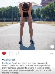 a woman standing in the middle of an empty road with her hands on her hips