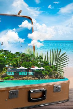 an open suitcase sitting on top of a wooden floor next to the ocean and beach