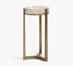 a gold and white side table with a marble top on an isolated surface, viewed from the front