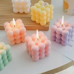 four candles that are sitting on a table