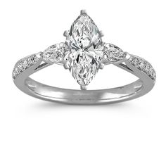 a white gold ring with a pear shaped diamond