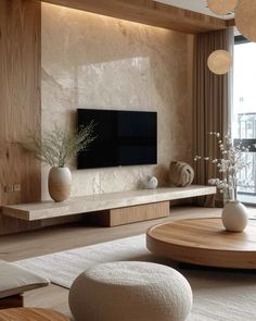 a living room filled with furniture and a flat screen tv on top of a wooden shelf