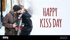 a man and woman kissing in front of a happy kiss day sign