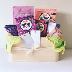 a wooden box filled with lots of different types of snacks and candy bars on top of a white table