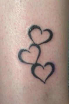 two hearts are drawn on the back of a woman's arm