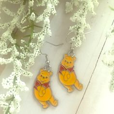 If You’re A Disney Fanatic Like Me, You’re Going To Love These. Winnie The Pooh Earrings For Sale! These Earrings Are So Cool. They Are Handmade By Me. They Are Absolutely One Of A Kind. They Are Made For Pierced Ears, And They Feature Cute Winnie The Pooh Charms Hanging From Each Earring. The Earrings Are A Little Over 1 1/2 Inches Tall, And A Little Over 1/2 Inch Wide. They Are Perfect! #Winniethepoohearrings Measurements: A Little Over 1/2 Inch Wide A Little Over 1 1/2 Inches Tall Winnie The Pooh Ears, Disney Earrings, Cute Winnie The Pooh, Disney Fanatic, So Cool, Pierced Ears, Orange Red, Winnie The Pooh, Ear Piercings