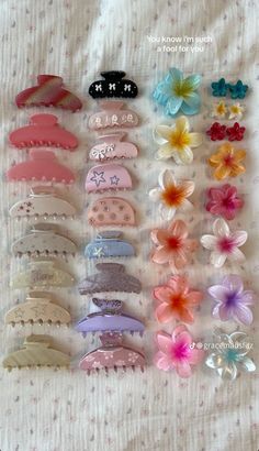 many different types of hair clips on a bed