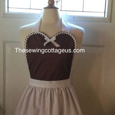 the apron is brown and white with a bow at the neckline, and there is no image on it