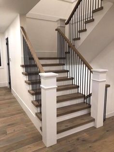 a staircase with wooden handrails and white railing