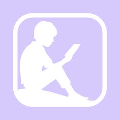 a person sitting on the floor with a book in their lap and reading it,