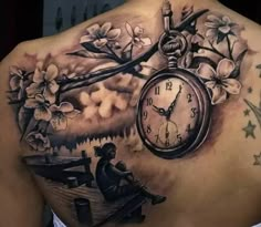 the back of a woman's shoulder with an alarm clock and flowers on it