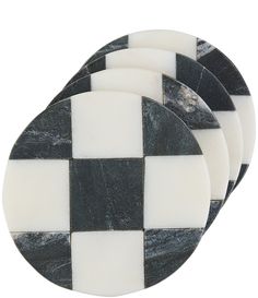 three black and white checkered coasters sitting side by side on a white background