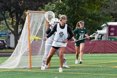 the girls are playing lacrosse on the field