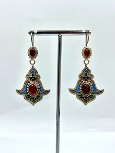 Statement silver dangle turkmen earring. Red carnelian stone, a precious stone, was used in bohemian earrings. Cloisonne earring decorated with colorful and high quality cloisonne. Tribal earrings made very clean and precise by masters. Turkmen coupes with this unique design are completely handmade. Total weight of ethnic earrings is 7.9 grams PRODUCT İNFORMATİON : Material : SİLVER Weight   : 7.90 GR Length   : 5.5 CM Width     : 2.8CM DELİVERY TİME : AMERİCA                  : 3-7 DAYS EU COUN Traditional Multicolor Brass Earrings, Vintage Multicolor Brass Earrings, Ornate Red Teardrop Jewelry, Traditional Red Earrings For Festival, Bohemian Teardrop Danglers For Gifts, Nickel-free Bohemian Pendant Earrings, Ornate Red Drop Earrings, Ornate Pendant Earrings For Festive Occasions, Bohemian Pierced Danglers As Gift