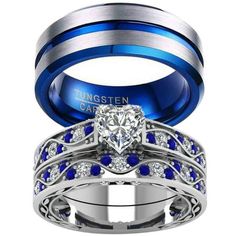 two wedding rings with blue and white stones on them, one has a heart shaped diamond in the center