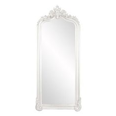 an ornate white mirror on a white wall