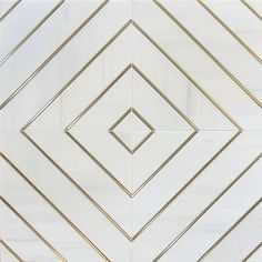 a white and gold tiled wall with lines