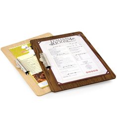 a wooden cutting board with a menu on top of it and a pen in the middle