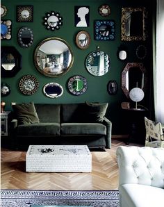 a living room filled with furniture and lots of mirrors