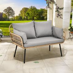 a couch sitting on top of a tiled floor