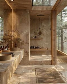 a large bathroom with two sinks and mirrors on the wall next to each other in front of trees