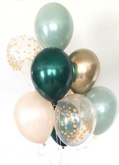 a bunch of balloons with gold and silver confetti on them in a vase