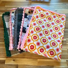 four pieces of cloth sitting on top of a wooden floor