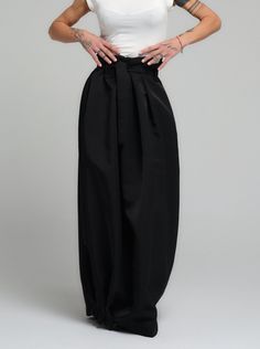 Make a bold statement with our high-waist skirt, the epitome of tailored elegance. This skirt is fashioned from premium polyester, delivering a smooth finish with a substantial feel that gracefully flows with every step. The design is accentuated by a tasteful belt that cinches the waist, while the elasticated back ensures a snug and comfortable fit. Its voluminous silhouette and sleek lines make it a versatile piece for both office wear and evening affairs. FEATURES:Includes a chic belt, elasticated back for comfort, and a high-waist cut 100% Handmade. SIZE & FIT: Fit: A relaxed fit with room to moveModel is wearing size Small or S/M View our SIZE CHART before ordering MATERIALS & CARE: Content: Polyester Care: Dry cleaning only SHIPPING: Made to order, processing time is 15 working days Chic Fitted Skirt With Wide Waistband, Chic Flared Skirt With Wide Waistband, Chic Fitted Pleated Skirt With Belt Loops, Chic High Waist Pleated Bottoms, Summer Evening Bottoms With Pleated Waist, Formal High-waist Fitted Maxi Skirt, Formal High Waist Fitted Maxi Skirt, Elegant Pleated Skirt With Elastic Waistband, Chic Flowy Skirt With Wide Waistband