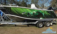 a boat is parked on the trailer in the grass