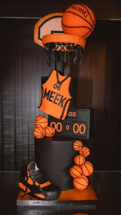 a cake made to look like basketballs and shoes on top of a black table