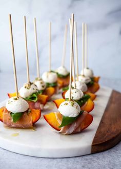 small appetizers are arranged on a platter with toothpicks in them