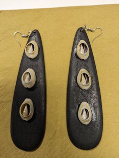 Drop down earrings. Shell accents. Available in black and brown. 5.5 inches long. Allow 2-5 business days for delivery Unique Black Pierced Earrings, Unique Black Teardrop Earrings, Accent Earrings, Earrings Wood, African Earrings, Wedding Jewelry Earrings, Wooden Earrings, Shell Earrings, Wood Earrings