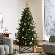 a living room with a christmas tree in the corner