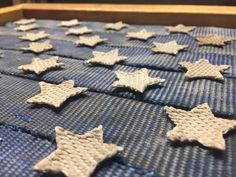 many small white stars are placed on a blue mat