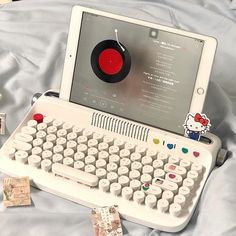 an old fashioned computer with a hello kitty sticker on it's keyboard and mouse pad